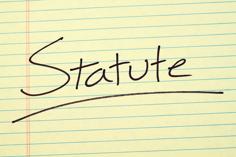 Yellow legal pad with text, "Statute"