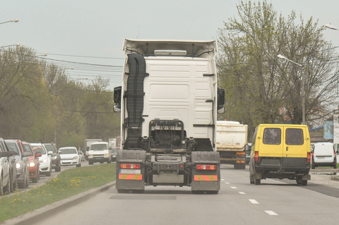 White semi truck on a crowded interstate